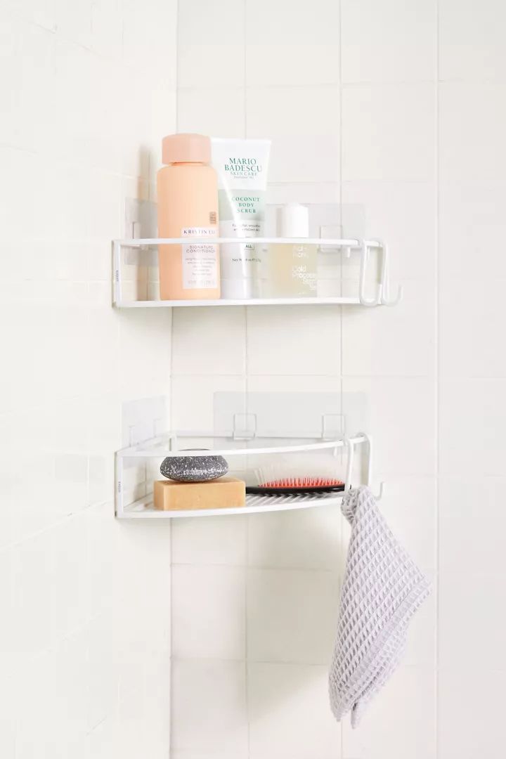 two white shelves with hair products on them and a towel hanging from the wall next to each other