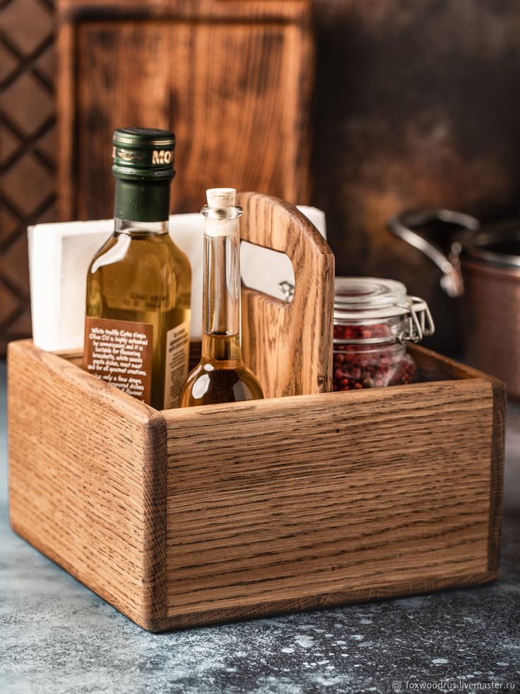 a wooden box filled with bottles of wine and other items on top of a table