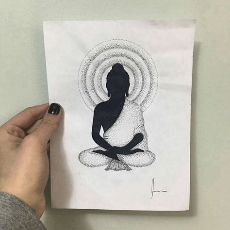 a person holding up a piece of paper with a drawing of a woman sitting in the middle