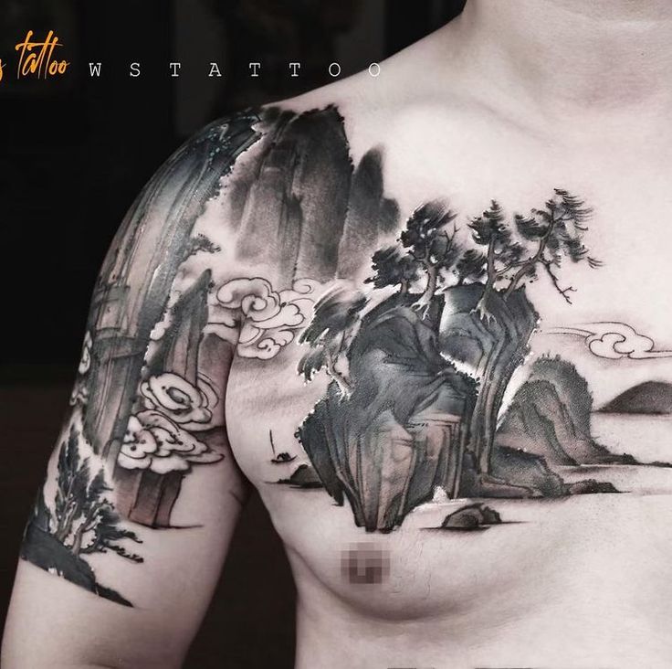 a man's chest is covered in black ink with mountains and trees on it