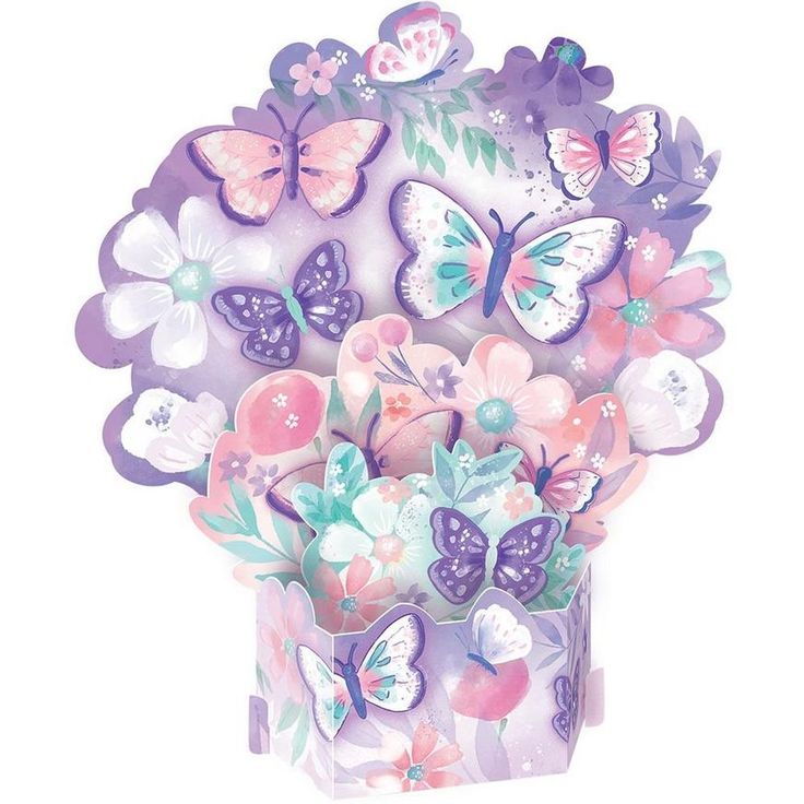 a vase filled with lots of butterflies on top of a white table topped with pink and purple flowers