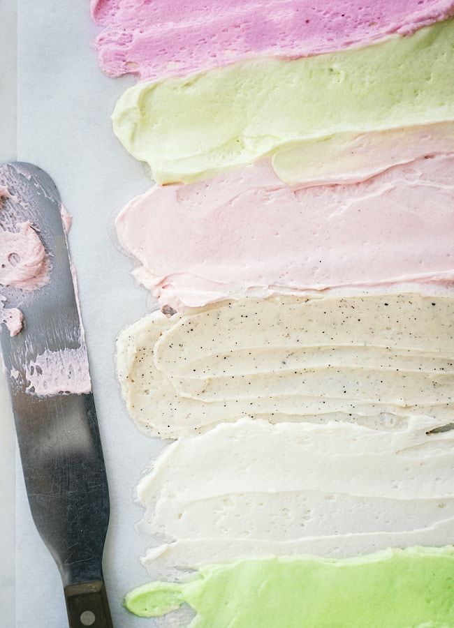 there is a knife next to some cake icing on the table with it's color swatches