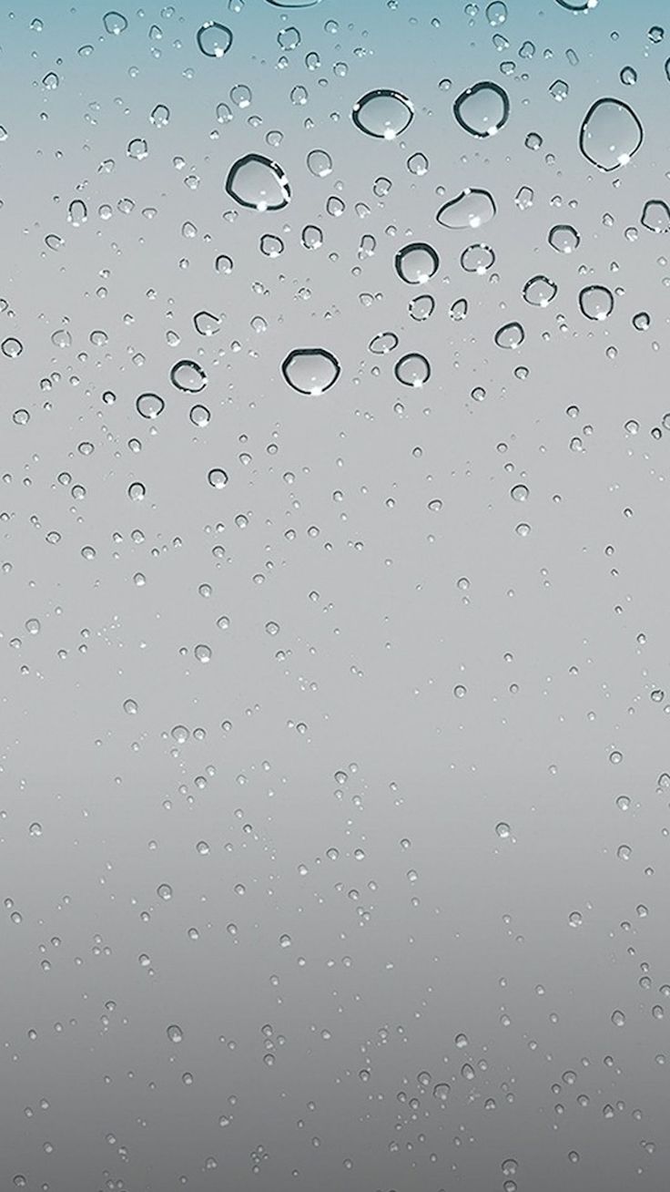 water drops on the window glass with blue sky in background