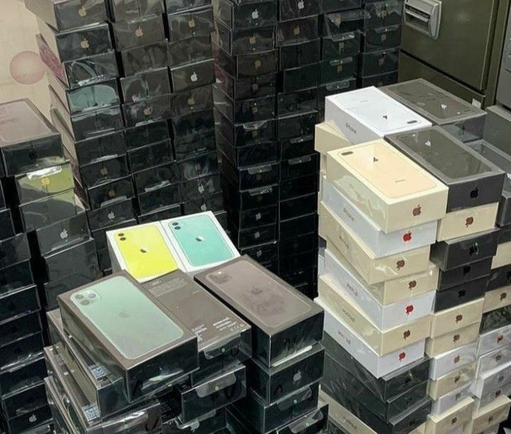 several stacks of electronic devices are stacked on top of each other in an electronics store