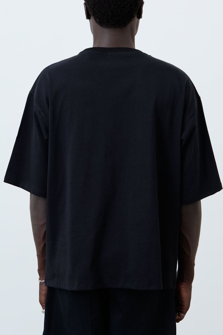 Heavyweight oversized tee with logo embroidery. DETAILS:- Dropped shoulder- Oversized silhouette COLOR: Black SIZE & FIT: Male model is 6’1 wearing a size L. Female model is 32 bust, 25 waist and wearing a size XL. FABRIC CONTENT: 100% Cotton CARE INSTRUCTIONS: Machine wash. Air dry. Do not machine dry. Black Graphic Tee With Drop Shoulder, Black Drop Shoulder Graphic Tee, Black Urban T-shirt With Drop Shoulder, Urban Black Drop Shoulder T-shirt, Black Drop Shoulder Urban T-shirt, Black Drop Shoulder Top For Streetwear, Oversized Black Drop Shoulder Top, Urban Black Drop Shoulder Tops, Urban Style Black Drop Shoulder Top