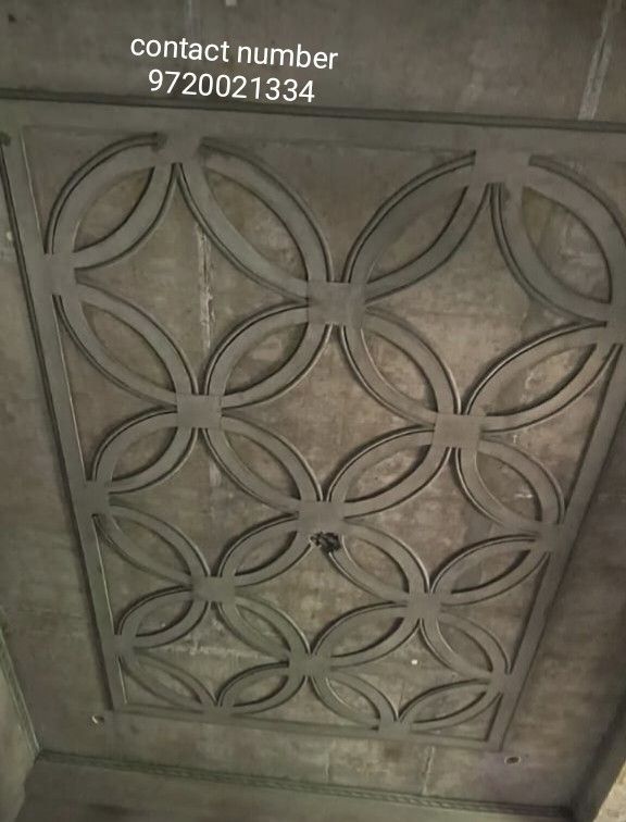 an image of a decorative ceiling in a bathroom with concrete walls and flooring that looks like it has been cast iron