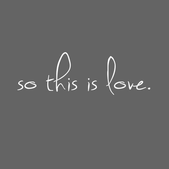 the words'so this is love'written in white ink on a gray background