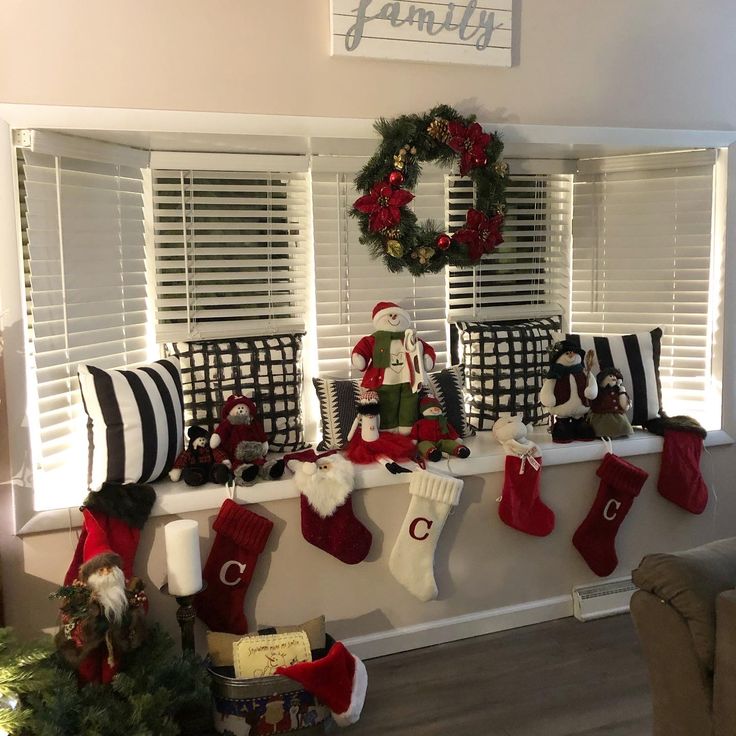 christmas stockings and santa hats are hung on the window sill