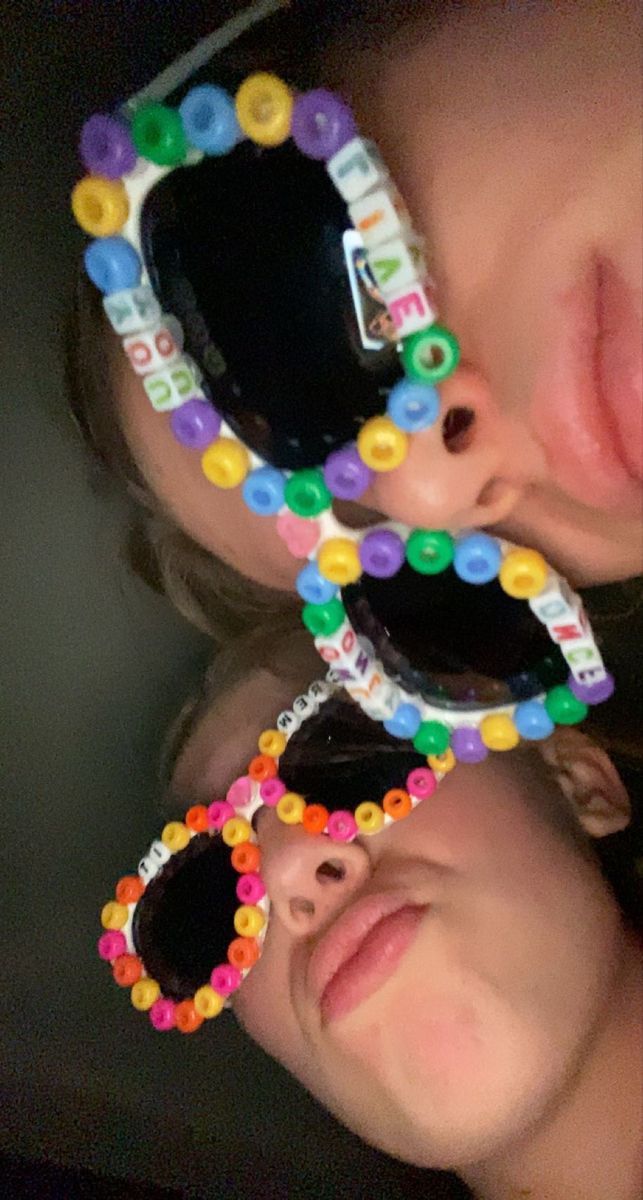 two children wearing sunglasses with beads on them