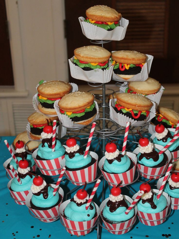 cupcakes and cookies are arranged on a table