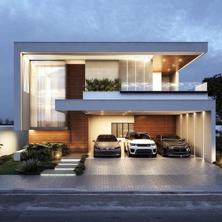 two cars parked in front of a modern house