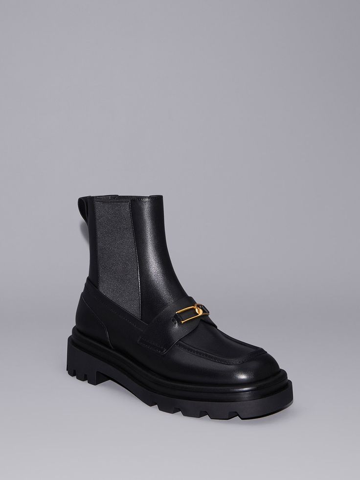 This item is part of our Online Exclusive selection, which consists of unique colourways and designs that are only available for purchase at CHARLESKEITH.COM. Combining the preppy style of loafers with the sturdiness of an ankle boot, these Gabine Chelsea boots showcase a unique, modern aesthetic that will elevate your cold-weather ensembles. Characteristic of our signature Gabine range, they feature interlocking U-shaped buckles across the vamps that gleam gold against an all-black finish to Fall Workwear Platform Boots With Lug Sole, Workwear Ankle Platform Boots With Lug Sole, Chic Boots With Lug Sole For Work, Modern Ankle Platform Boots For Work, Chic Workwear Boots With Lug Sole, Winter Workwear Mid-calf Boots With Lug Sole, Chic High Ankle Moto Boots For Workwear, Workwear Mid-calf Boots With Lug Sole And Round Toe, Trendy Flat Heel Workwear Boots