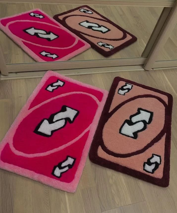 three bathroom rugs on the floor in front of a mirror