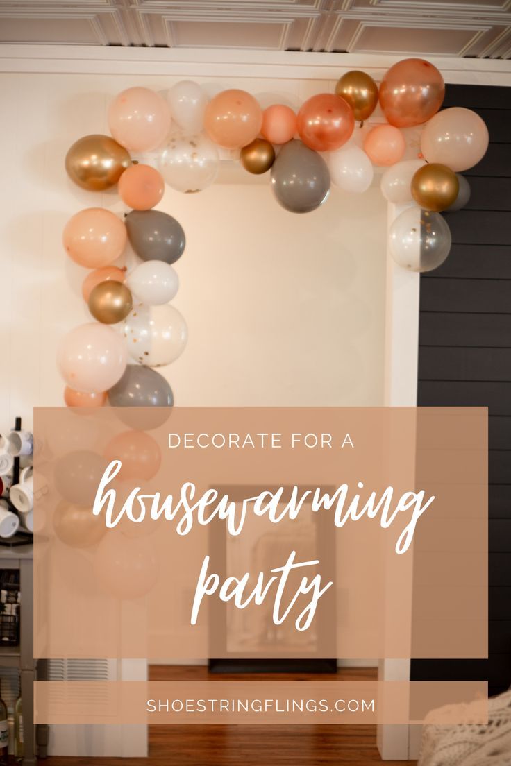 a housewarming party with balloons and streamers in the shape of a heart