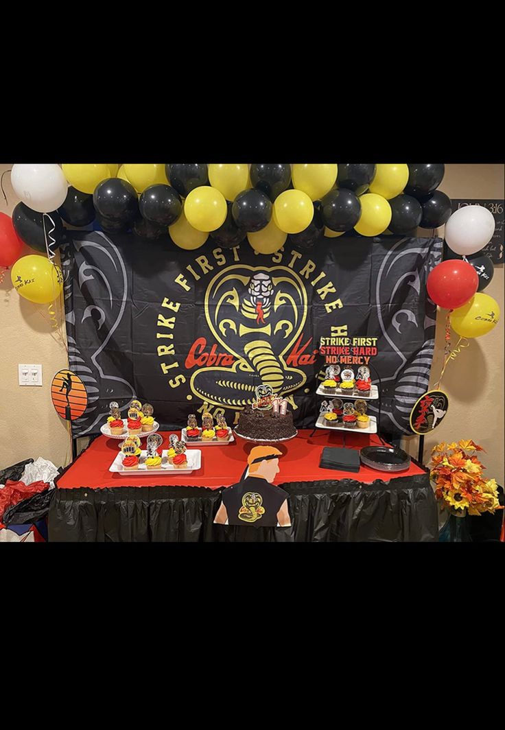 a table topped with balloons and cake