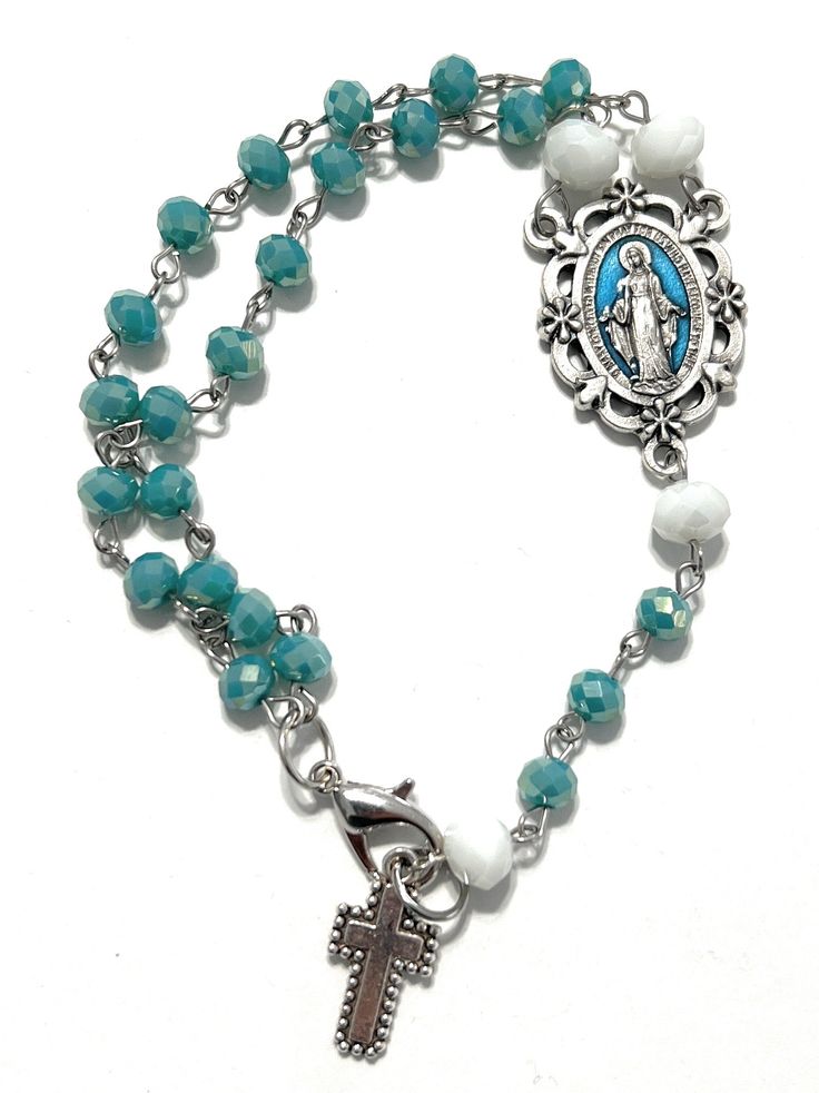 Details: I am excited to present this beautiful hand beaded Religious Rosary I designed. I always love learning new techniques to create amazing & unique gifts for my customers! Rosary symbolizes a chain of roses and the roses are prayers. The Rosary Prayer tells us about the life of Jesus and his Mother, Mary. If you want to purchase one similar to this or have me customize a design for you please contact me: info@madarifashions.com. We can include your favorite sports teams, inspirational word Faceted Beads Rosary Bracelet For Gift, Bohemian Rosary Bracelet With Faceted Beads As Gift, Bohemian Rosary Bracelet With Faceted Beads, Adjustable Beaded Chain Rosary Bracelet Gift, Adjustable Beaded Chain Earrings As Gift, Silver Jewelry With Faceted Beads For Crafting, Adjustable Rosary With Oval Beads As Gift, Silver Rosary Bracelet With Colorful Beads For Gifts, Beaded Rosary With Oval Beads As Gift