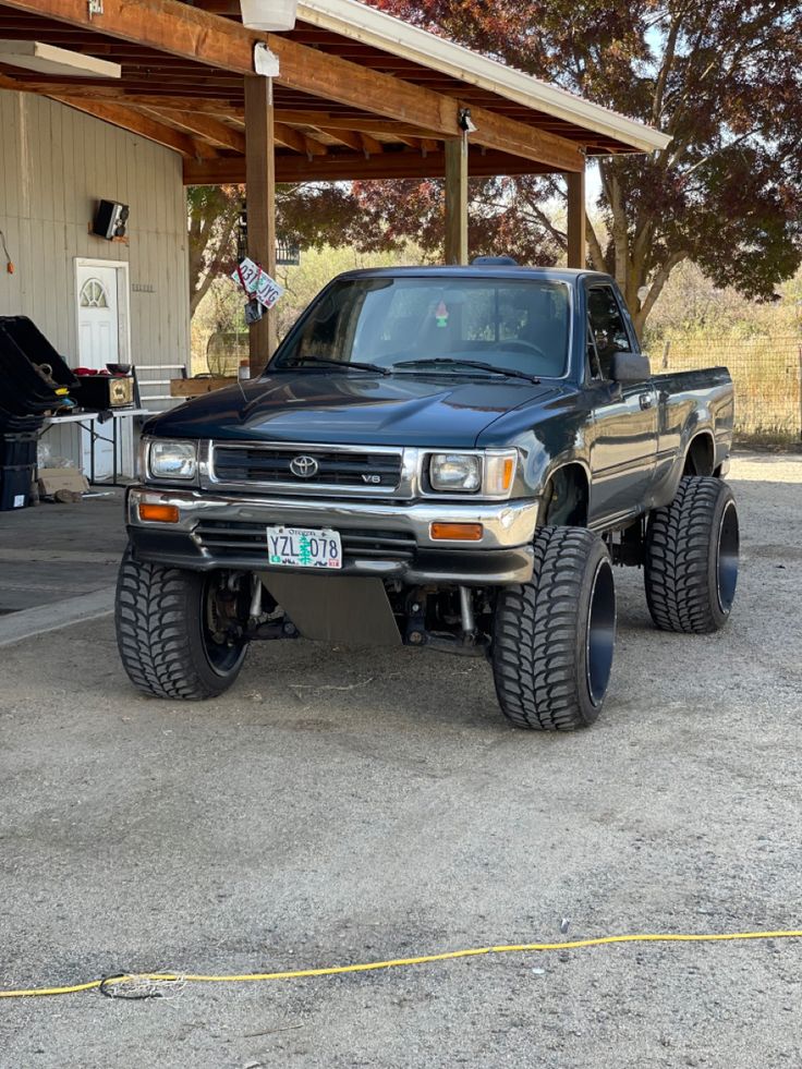 a black truck parked in front of a building