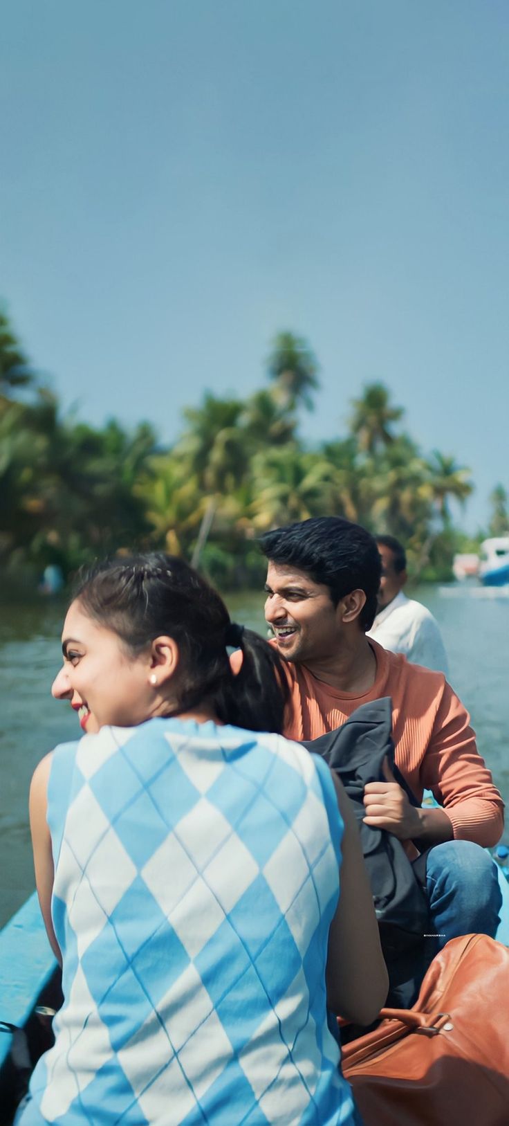 two people are riding in a boat on the water