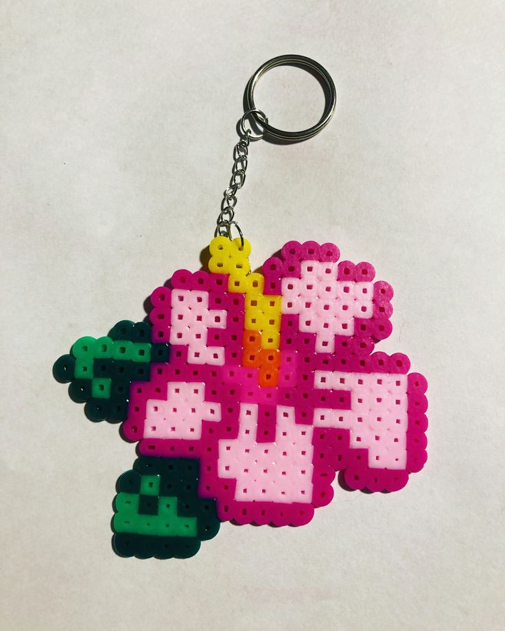 a pixel keychain that has been made to look like an old school video game character