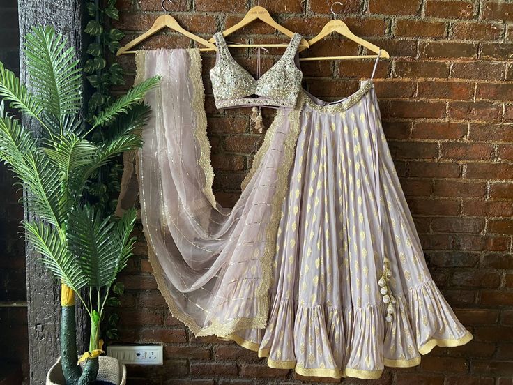 Mauve Raw silk blouse with mirror and pearl hand embroidery, paired with butti georgette ruffle skirt and organza sequin work dupatta and scalloped edging Mauve Lehenga, Sari Embroidery, Ruffle Lehenga, National Institute Of Design, Raw Silk Blouse, Raw Silk Lehenga, Mirror Work Blouse, Yellow Lehenga, Ivory Blouse