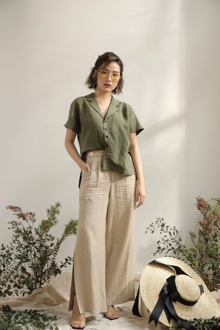 A staple that works overtime. The Linen Workwear Shirt features a notched collar, a clean button front, relaxed short sleeves and a boxy shape. Plus, it’s made of light, breathable linen, so it’ll keep you looking (and feeling) naturally cool all season long. Natural Pants Outfit, Linen On Linen Outfit, Linen Korean Style, How To Style Baggy Linen Pants, Ivory Linen Pants Outfit, Scandinavian Clothing Style Summer, Minimalist Female Fashion, Dark Brown Linen Pants Outfit, Fabric Pants Outfits