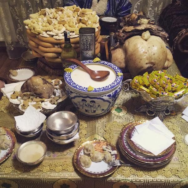 a table topped with lots of different types of dishes and bowls filled with food next to each other