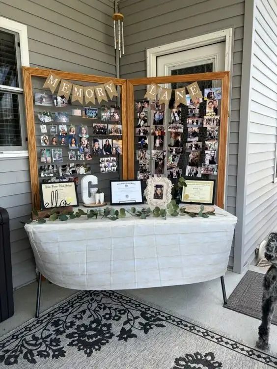 a dog standing in front of a table with pictures and decorations on it's side