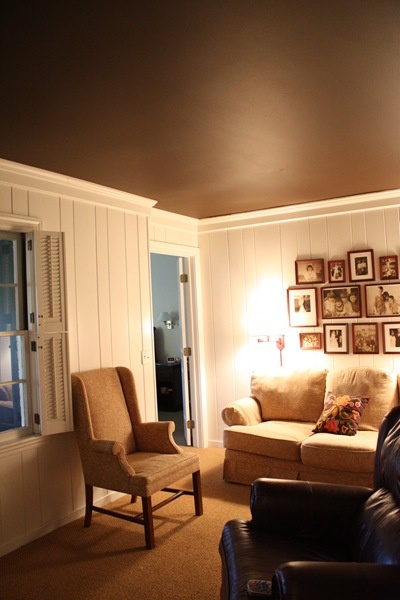 a living room filled with furniture and pictures on the wall