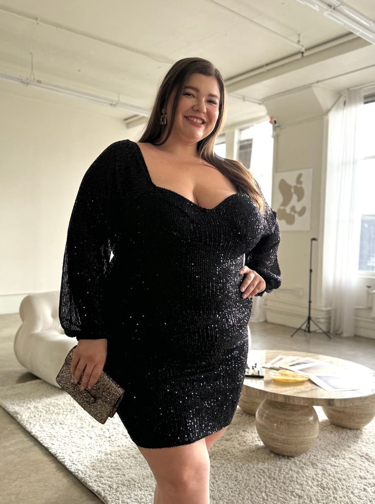 The Plus Size Sparkly Sequin Bodycon Mini Dress is an alluring must-have for your wardrobe! Because it's made out of a dazzling fabric covered in glittery sequins, you're sure to stand out in this dress. Sultry and fun, this feminine piece is sure to turn heads and make a statement! This dress features long sleeves, a padded bust, a zipper down the back, elastic hems, and sequins all over. The material is a stretchy, glittery material. It is made out of 95% Polyester and 5% Spandex. Imported. Ha