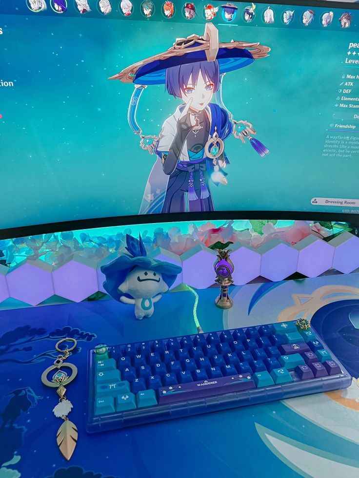 a computer monitor with an anime character on it's screen and keychains