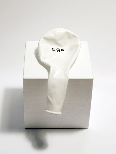 a white ceramic object with the word e g on it