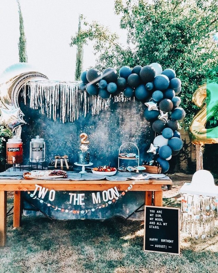 an outdoor party with balloons and decorations