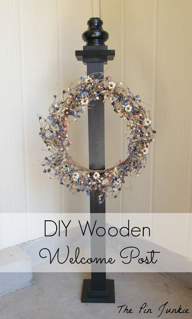 a welcome post with a wreath on it and the words diy wooden welcome post