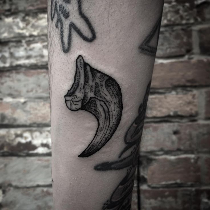 a black and white photo of a tattoo on the leg