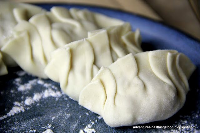 some dumplings are sitting on a blue plate