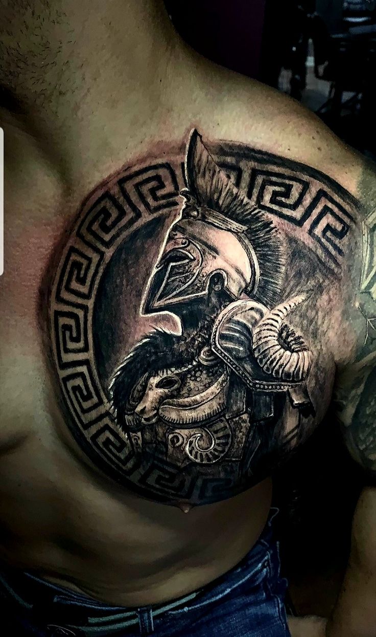 a man's chest with an eagle and helmet on it