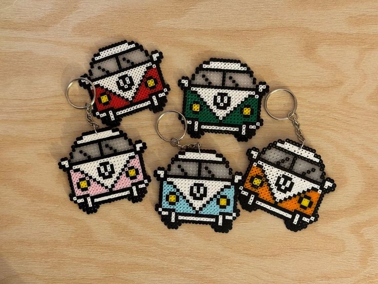 four keychains made to look like the vw bus