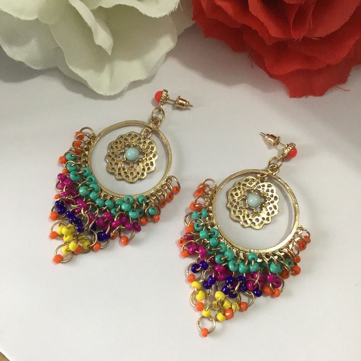 Very beautiful, elegant and high quality hand crafted golden multi colour earrings will add charm and charisma to your beautiful personality. Wear it with any of your formal or casual outfits and grab compliments all the way. Main Colour: gold Beads: Seed Bead Bead Colour: Multi Colour  Earrings Size: L x 7.7 cm / W x 3.8 cm Luxury Multicolor Bollywood Jhumkas, Multicolor Metal Chandbali Earrings, Multicolor Metal Earrings For Festivals, Traditional Multicolor Metal Earrings, Fusion Style Drop Earrings For Festivals, Multicolor Chandbali Earrings For Festival, Multicolor Metal Chandbali Danglers, Bohemian Dangle Clip-on Earrings For Party, Multicolor Metal Dangle Jewelry