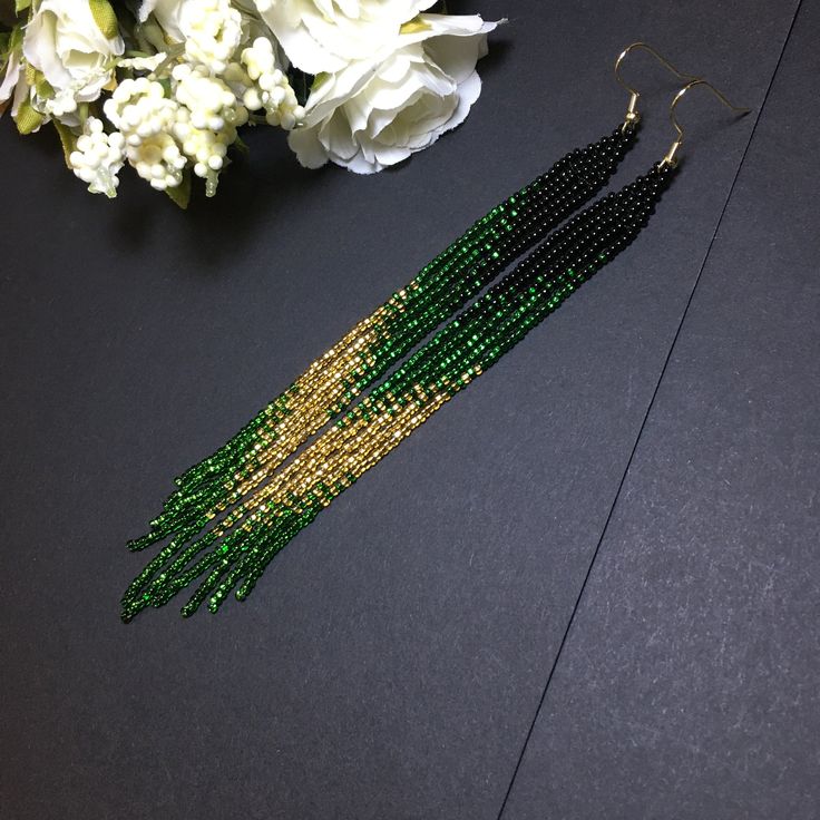 "These black green gold long fringe bead earrings pair amazingly with any outfit, dressy or casual. They are made of high-quality Czech colored beads with steel . Colors: black green gold Length: 7 inches (17.5 cm) Width: 0.5 inches (1 cm) Materials: Czech \"Preciosa\" beads Durable synthetic thread" Seed Bead Art, Extra Long Earrings, Seed Bead Jewelry Patterns, Beaded Earrings Tutorials, Beaded Earrings Diy, Native American Beaded Earrings, Thread Bangles, Handmade Earring, Beaded Earrings Patterns