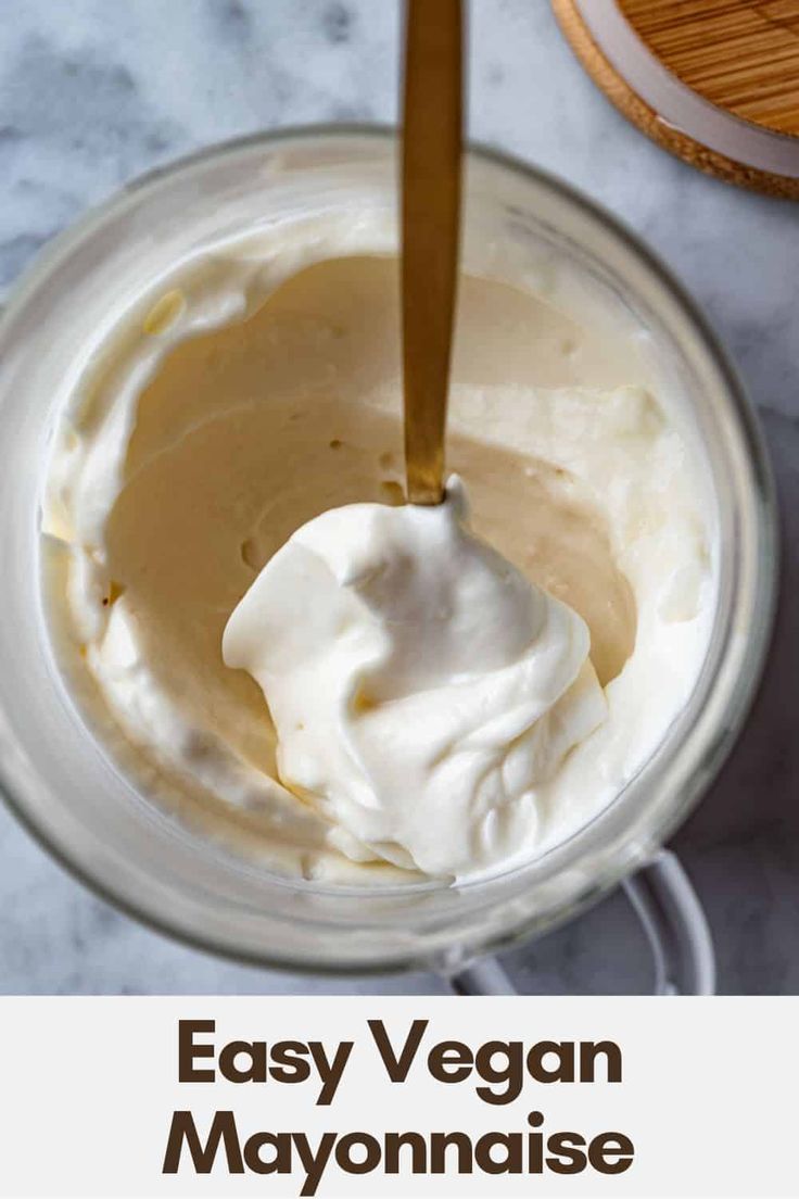 an easy vegan mayonnaise recipe in a glass jar with a wooden spoon