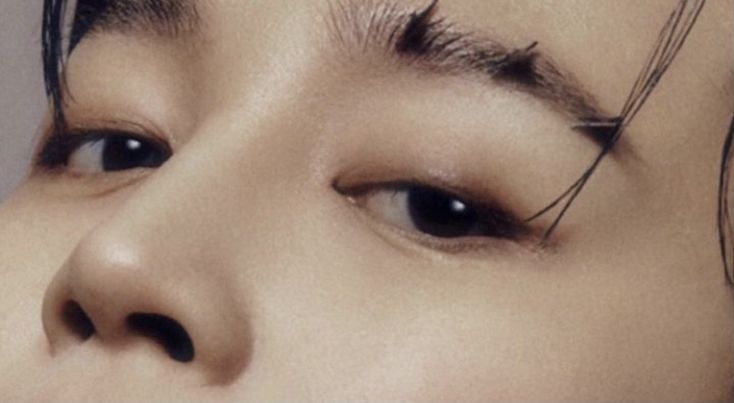 a close up of a person with long eyelashes