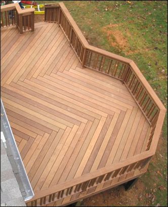 an overhead view of a wooden deck in a yard with two children playing on it