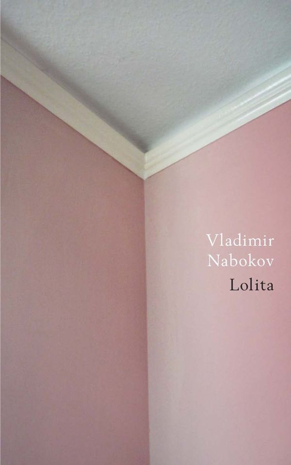 the corner of a room with pink walls and white trim