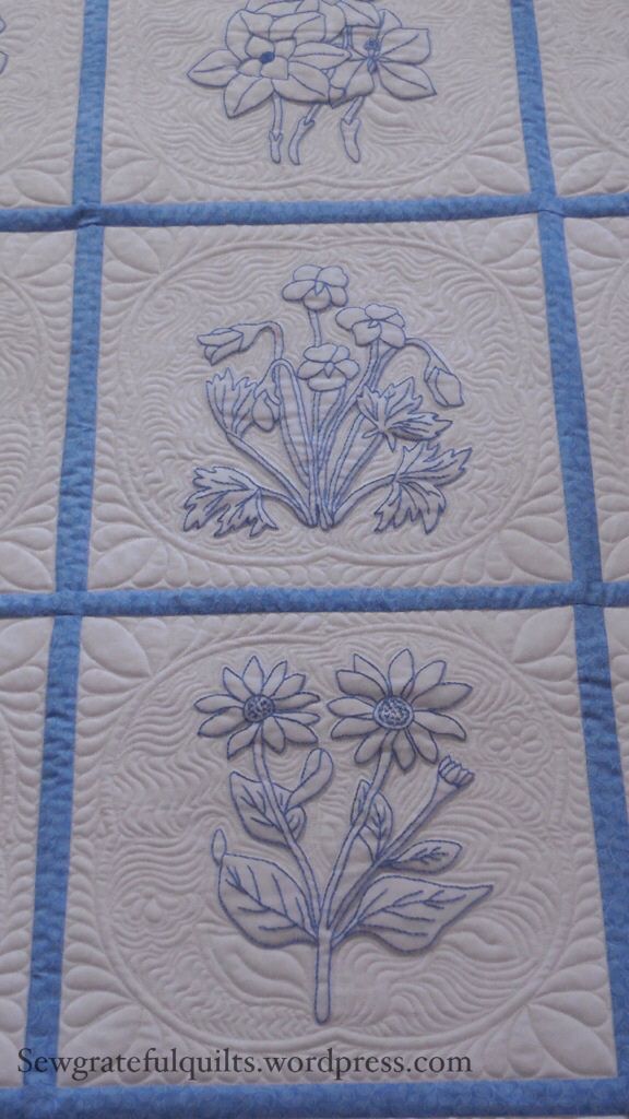 four quilts with flowers on them in blue and white colors, each featuring different designs