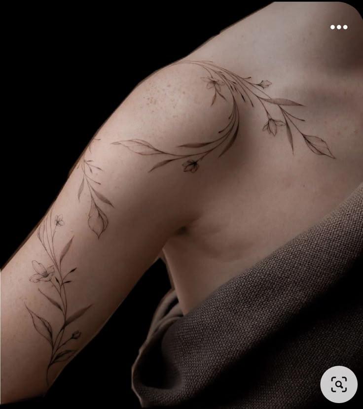 the back of a man's arm with flowers on it