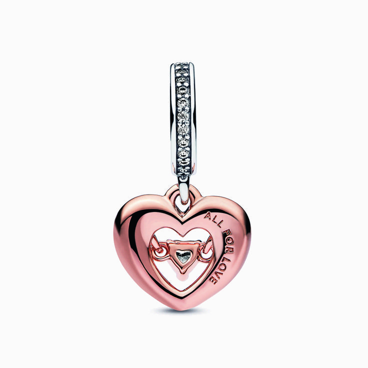 Wear your heart on your sleeve with our Two-tone Radiant Heart Dangle Charm. This 14k rose gold-plated open heart charm is detailed with hand-applied red enamel and a floating cubic zirconia heart within, symbolising the radiating energy of love. A sterling silver pav�bail and "All for love" engraving add an extra sparkle of romance. Style yours on your favourite Pandora Moments bracelet to tell your love story. Elegant Heart Charms For Mother's Day, Heart-shaped Rose Gold Charm Jewelry, Rose Gold Charms Jewelry For Valentine's Day, Rose Gold Heart Charm For Valentine's Day, Rose Gold Heart-shaped Charm For Gift, Heart Charms For Anniversary, Valentine's Day Rose Gold Heart Charm, Rose Gold Charms For Valentine's Day, Rose Gold Heart Charms For Valentine's Day