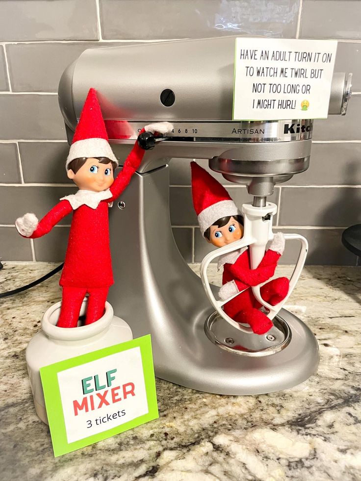 two elfs on top of an electric mixer with a sign that says, i have an hour time to watch the twin but not too long for 3 tickets