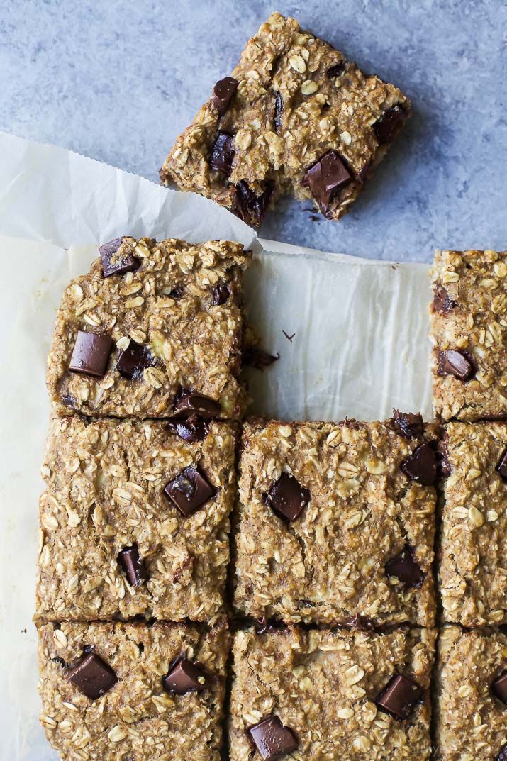 chocolate chip oatmeal bars cut into squares on top of parchmented paper