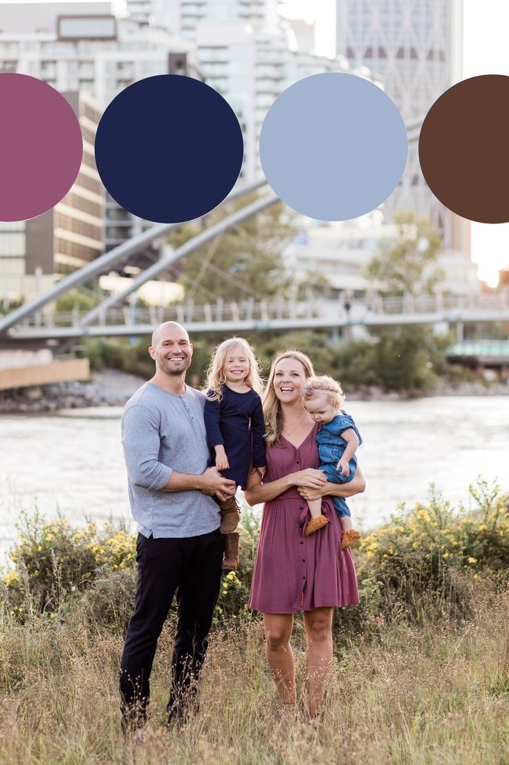 a family poses for a photo in front of a river and cityscape with circles above them