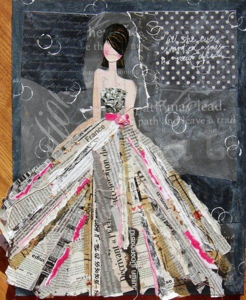 a woman in a dress made out of newspaper strips on a wooden table with a black background